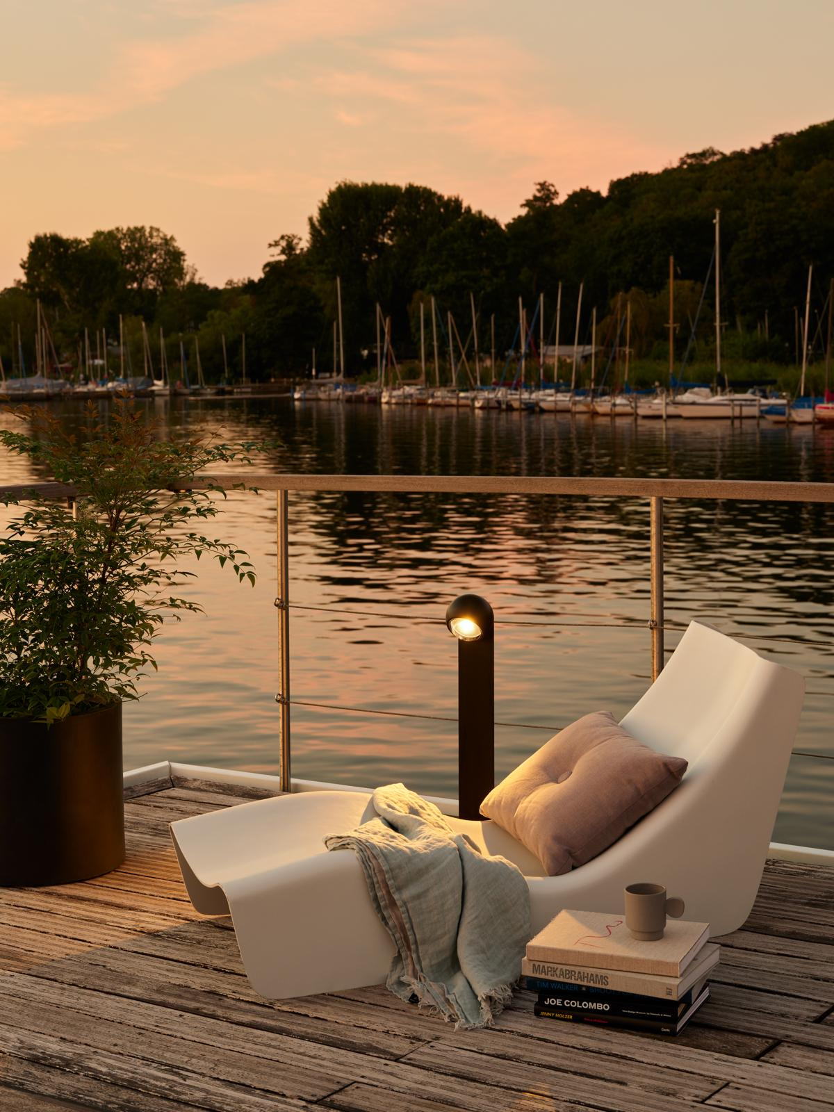 Deck lounge chair overlooking the marina at dusk